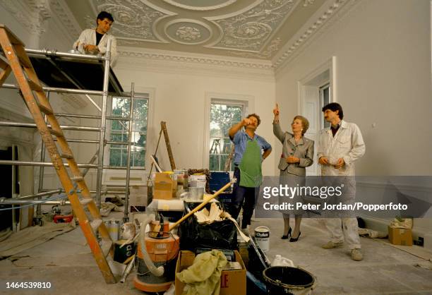 Conservative Party politician and Prime Minister of the United Kingdom Margaret Thatcher briefs painters and decorators as they work to complete the...