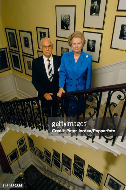 Conservative Party politician and Prime Minister of the United Kingdom Margaret Thatcher posed with her husband Denis Thatcher on the main staircase...