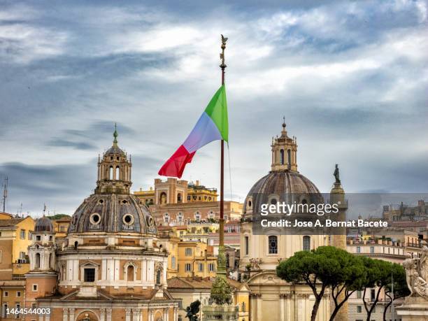 flag of italy flying over the city of rome in venice square. - italy v republic of ireland group e uefa euro 2016 stockfoto's en -beelden