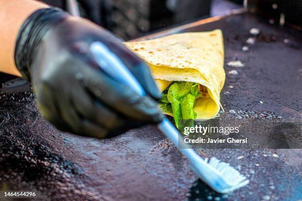 woman cooking savory pancakes on the grill, stuffed with vegetables (vegetarian food) - griddle stock pictures, royalty-free photos & images