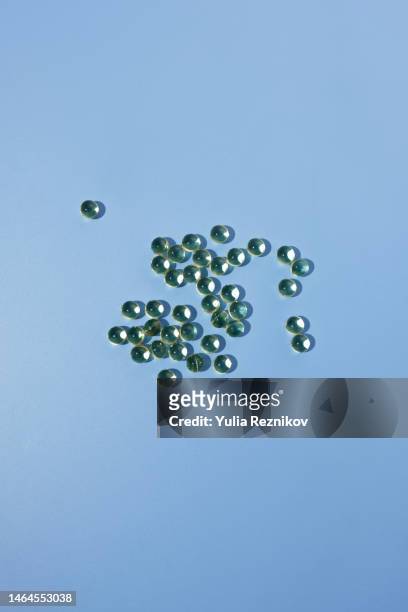 vitamin d pills on the blue background - fish oil stock photos et images de collection