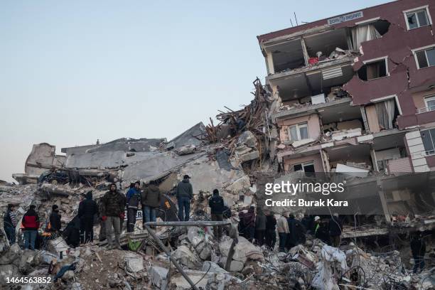 People wait for news of their loved ones, believed to be trapped under collapsed building on on February 09, 2023 in Hatay, Turkey. A 7.8-magnitude...
