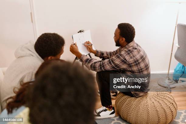 young man drawing for charades - mime stock pictures, royalty-free photos & images