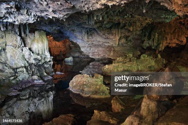 neptune cave, stalactite cave with lake, colourful rocks, bizarre landscape, sardinia, italy - neptune's grotto stock pictures, royalty-free photos & images