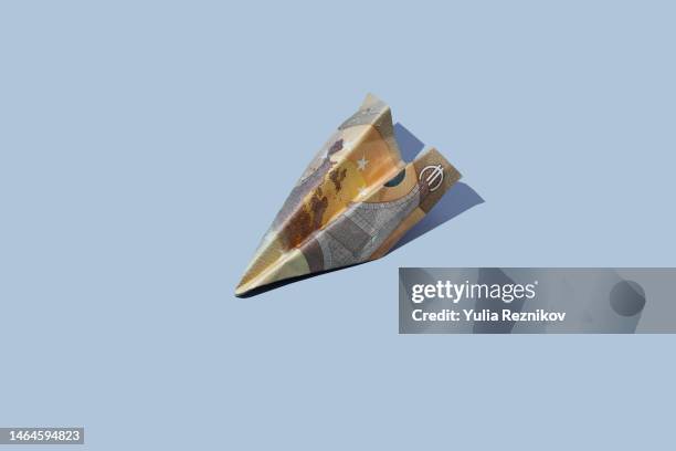 50 euro banknote in shape of airplane on the blue background - 50 euro stock pictures, royalty-free photos & images