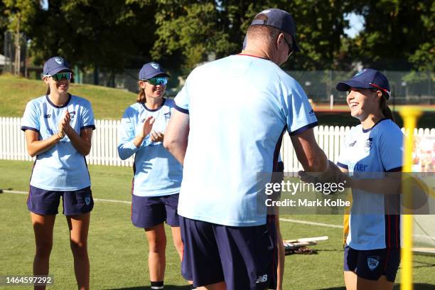 Isabella Malgioglio of the NSW Breakers is presented with her baggy blue by Breakers assistant coach Grant Lambert during her NSW cap presentation...
