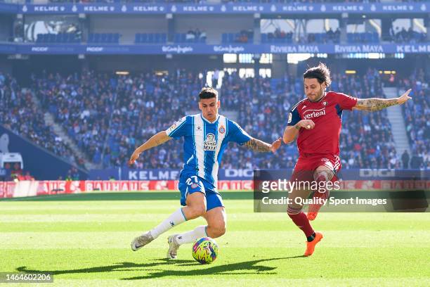 Ruben Sanchez of RCD Espanyol competes for the ball with Juan Cruz of CA Osasuna during the LaLiga Santander match between RCD Espanyol and CA...