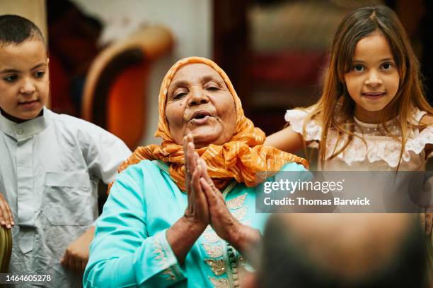 medium shot of grandmother and grandchildren during family dinner - arab community life bildbanksfoton och bilder