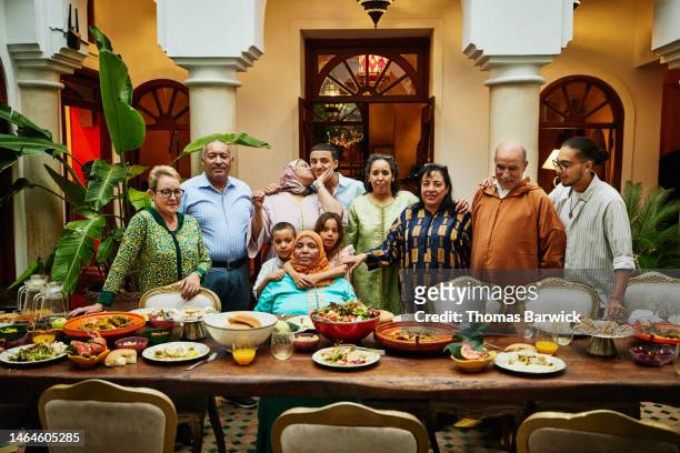 wide shot of multigenerational family gathered for celebration dinner - arab community life bildbanksfoton och bilder