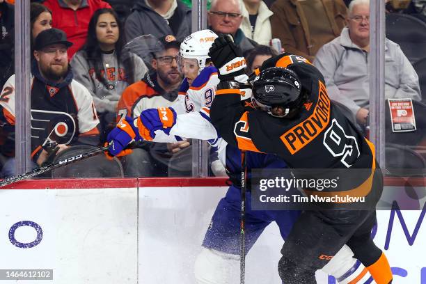 Ivan Provorov of the Philadelphia Flyers checks Connor McDavid of the Edmonton Oilers during the first period at Wells Fargo Center on February 09,...