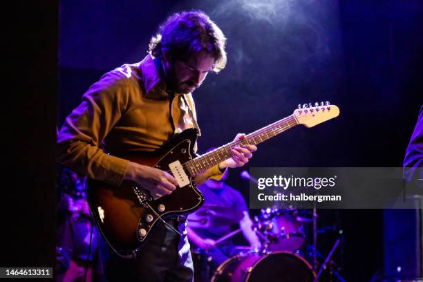 guitarist playing with band onstage - rock band concert stock pictures, royalty-free photos & images