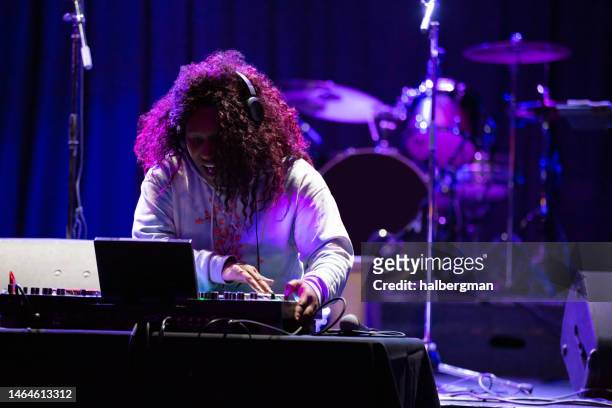 grinning dj performing at music venue - disc jockey stock pictures, royalty-free photos & images