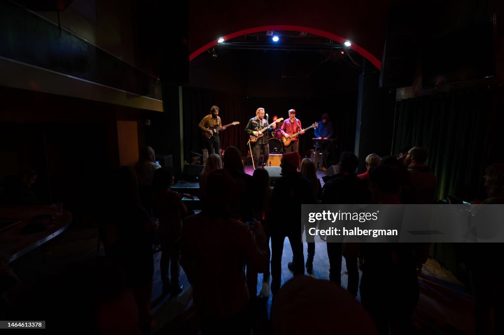Silhouetted Audience Watching Band Performing Onstage