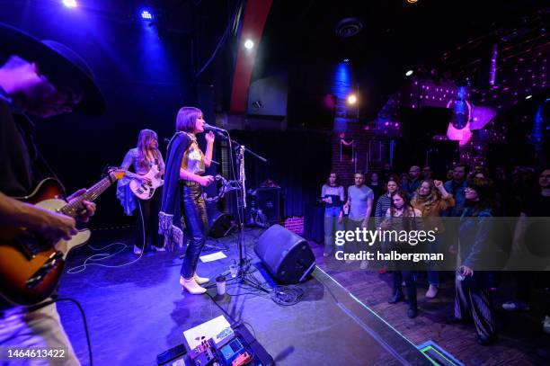 audience dancing to live band performing on stage at small venue - rock group stock pictures, royalty-free photos & images