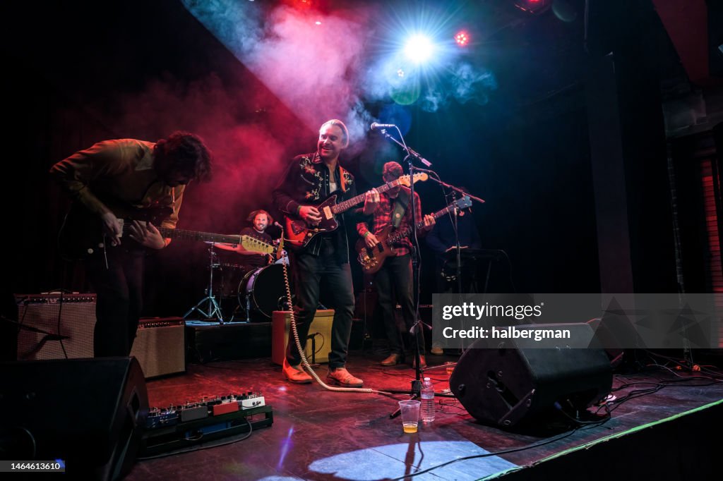 Grinning Musicians Performing On Stage