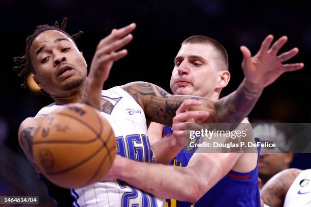 Markelle Fultz of the Orlando Magic and Nikola Jokic of the Denver Nuggets fight for the ball during the first quarter at Amway Center on February...