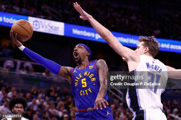 Kentavious Caldwell-Pope of the Denver Nuggets drives to the net as Moritz Wagner of the Orlando Magic defends during the first quarter at Amway...