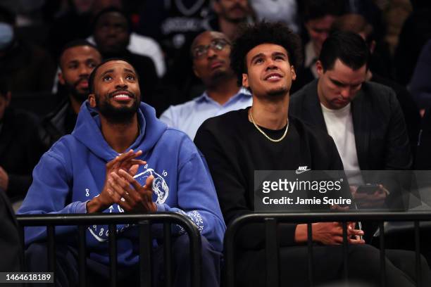 New Nets players Mikal Bridges and Cam Johnson watch from the crowd after being traded for Kevin Durant during the game against the Chicago Bulls at...