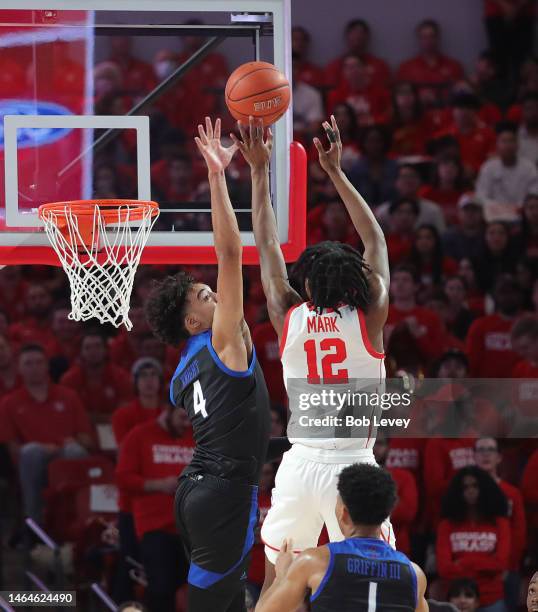 Tramon Mark of the Houston Cougars shoots over Brian Knight of the Tulsa Golden Hurricane at Fertitta Center on February 08, 2023 in Houston, Texas.