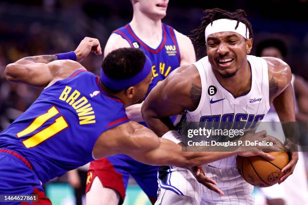 Wendell Carter Jr. #34 of the Orlando Magic and Bruce Brown of the Denver Nuggets fight for the ball during the third quarter at Amway Center on...