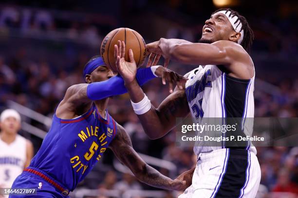 Wendell Carter Jr. #34 of the Orlando Magic drives for the net as Kentavious Caldwell-Pope of the Denver Nuggets defends during the third quarter at...