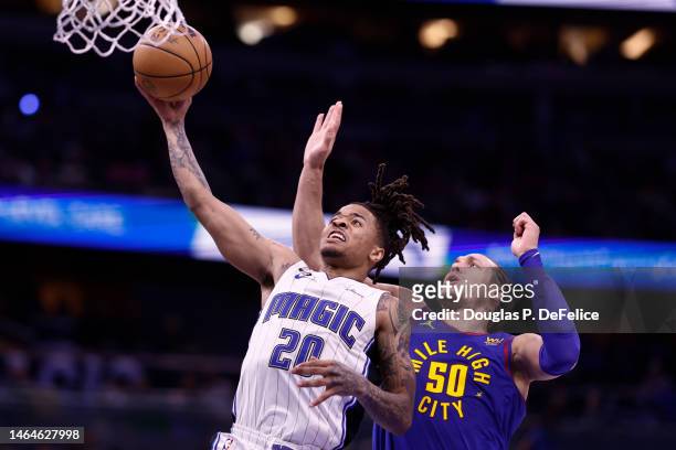 Markelle Fultz of the Orlando Magic drives to the net as Aaron Gordon of the Denver Nuggets defends during the third quarter at Amway Center on...