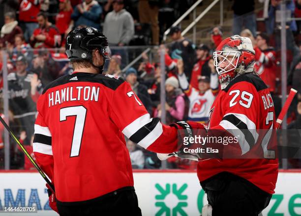 Dougie Hamilton and Mackenzie Blackwood of the New Jersey Devils celebrate the win over the Seattle Kraken during the third period at Prudential...