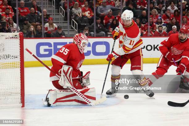 Ville Husso of the Detroit Red Wings makes a third period save on a shot by Mikael Backlund of the Calgary Flames at Little Caesars Arena on February...