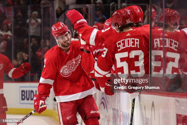 Filip Zadina of the Detroit Red Wings celebrates his second period goal with teammates while playing the Calgary Flames at Little Caesars Arena on...