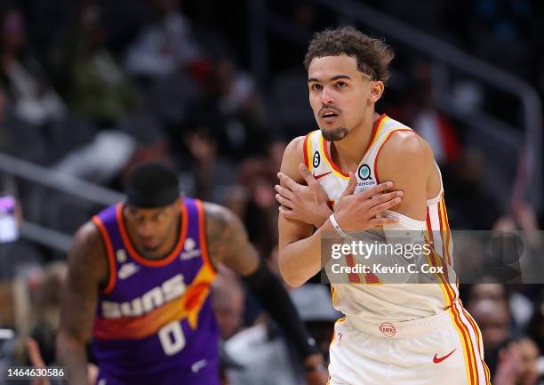 Trae Young of the Atlanta Hawks reacts after hitting a three-point basket against the Phoenix Suns during the fourth quarter at State Farm Arena on...