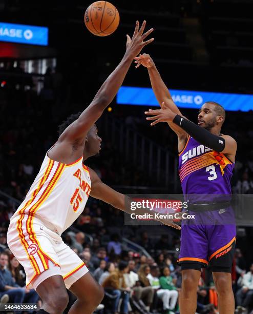 Chris Paul of the Phoenix Suns passes the ball against Clint Capela of the Atlanta Hawks during the fourth quarter at State Farm Arena on February...