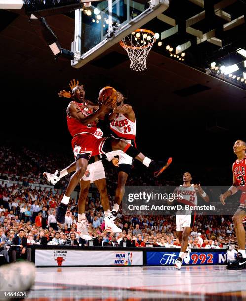 Michael Jordan of the Chicago Bulls attempts a reverse layup against Jerome Kersey of the Portland Trail Blazers during the 1992 NBA Finals in...