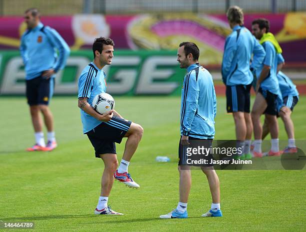 Cesc Fabregas of Spain stands with his teammate Andres Iniesta during a training session ahead of their UEFA EURO 2012 group C match against Croatia...