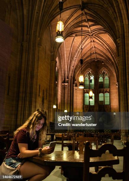 college student in the cathedral of learning, pittsburgh - hogwarts stock pictures, royalty-free photos & images