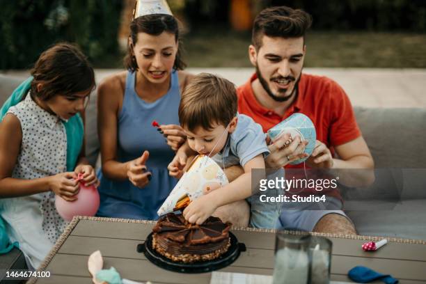 boy putting a hand into a cake - cake smashing stock pictures, royalty-free photos & images