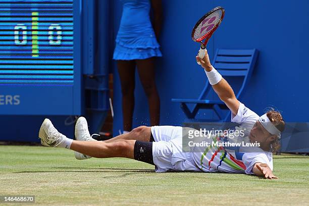 David Nalbandian of Argentina slips to the ground during his mens singles final round match against Marin Cilic of Croatia on day seven of the AEGON...