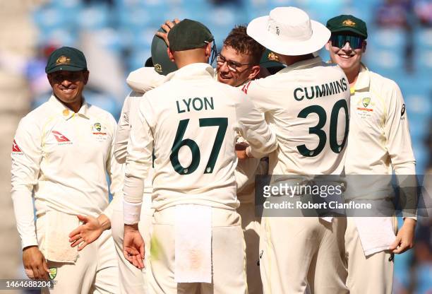 Todd Murphy of Australia is congratulated by team mates after taking his fifth wicket during day two of the First Test match in the series between...
