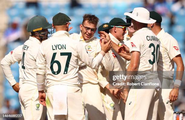 Todd Murphy of Australia is congratulated by team mates after taking his fifth wicket during day two of the First Test match in the series between...