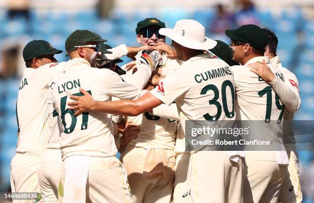 Todd Murphy of Australia is congratulated by team mates after taking his fifth wicket during day two of the First Test match in the series between...