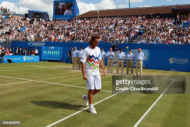 David Nalbandian of Argentina leaves the court dejected after being disqualified for unsportsmanlike conduct during his mens singles final round...