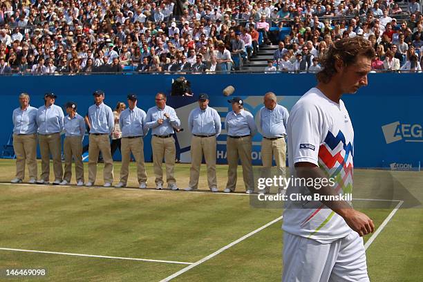 David Nalbandian of Argentina leaves the court dejected after being disqualified for unsportsmanlike conduct during his mens singles final round...