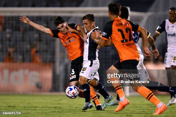 Joshua Nisbet of the Mariners takes on the defence of Henry Hore of the Roar during the round 16 A-League Men's match between Brisbane Roar and...