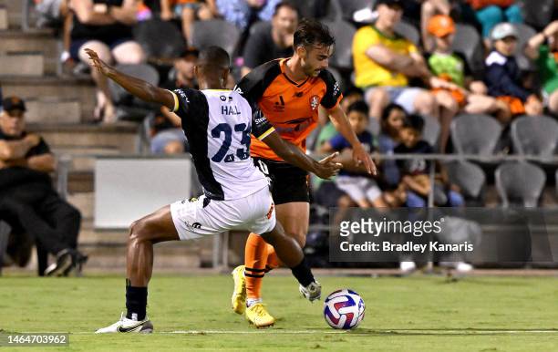 Nikola Mileusnic of the Roar takes on the defence of Daniel Hall of the Mariners during the round 16 A-League Men's match between Brisbane Roar and...