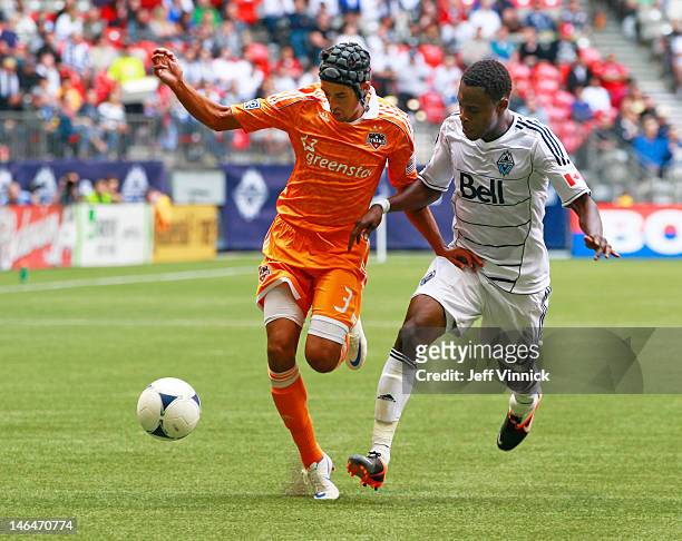 Calen Carr of the Houston Dynamo and Gershon Koffie of the Vancouver Whitecaps FC battle for the ball during their MLS game at BC Place June 10, 2012...