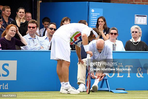 David Nalbandian of Argentina looks at the line judge's bloody leg after injuring him during his mens singles final round match against Marin Cilic...