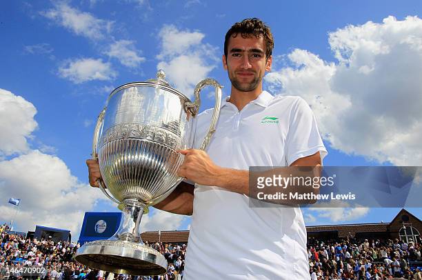 Marin Cilic of Croatia poses with the winner's trophy after David Nalbandian of Argentina was disqualified for unsportsmanlike conduct after his mens...