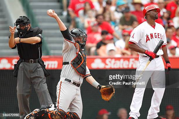 Home plate umpire Angel Campos calls a strike on Torii Hunter of the Los Angeles Angels of Anaheim as Matt Wieters of the Baltimore Orioles catches...