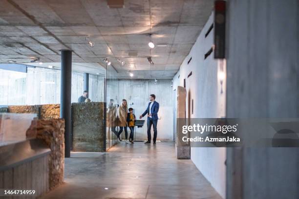 a museum guide letting in a group of visitors - curator stock pictures, royalty-free photos & images