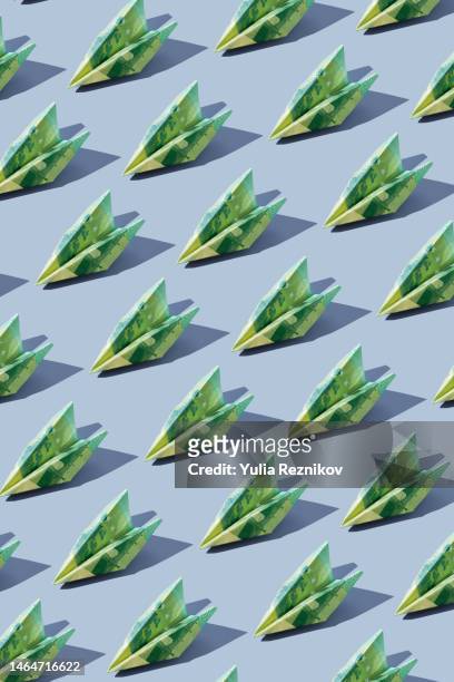 repeated 100 euro banknotes in shape of airplanes on the blue background - 100ユーロ紙幣 ストックフォトと画像