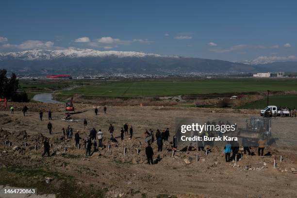 People burry the victims of the earthquake to the mass graves on February 10, 2023 in Hatay, Turkey. A 7.8-magnitude earthquake hit near Gaziantep,...